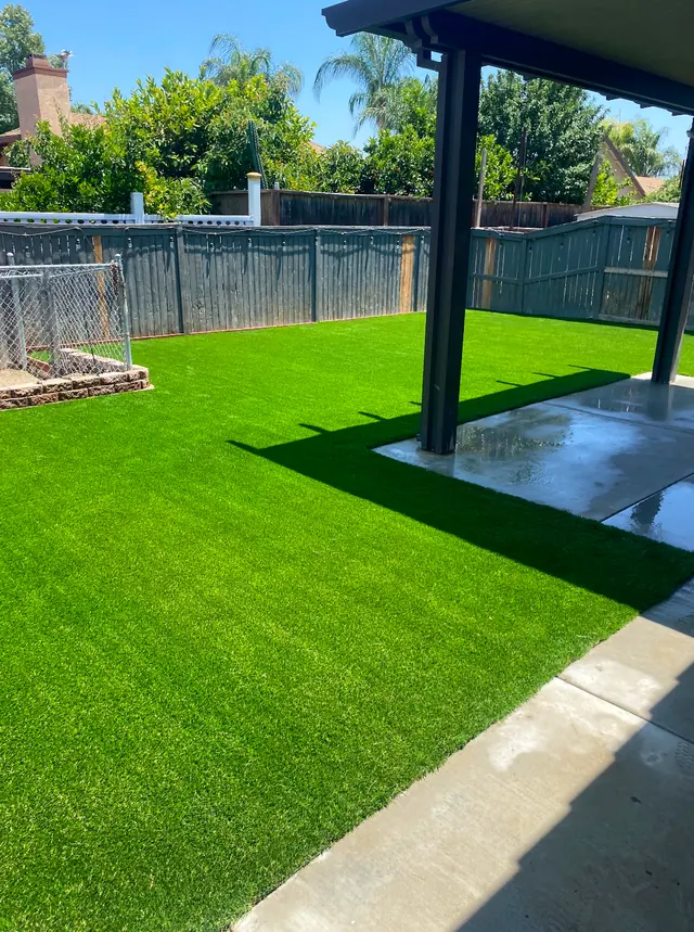 Artificial turf next to fresh concrete in a Perris, CA back yard