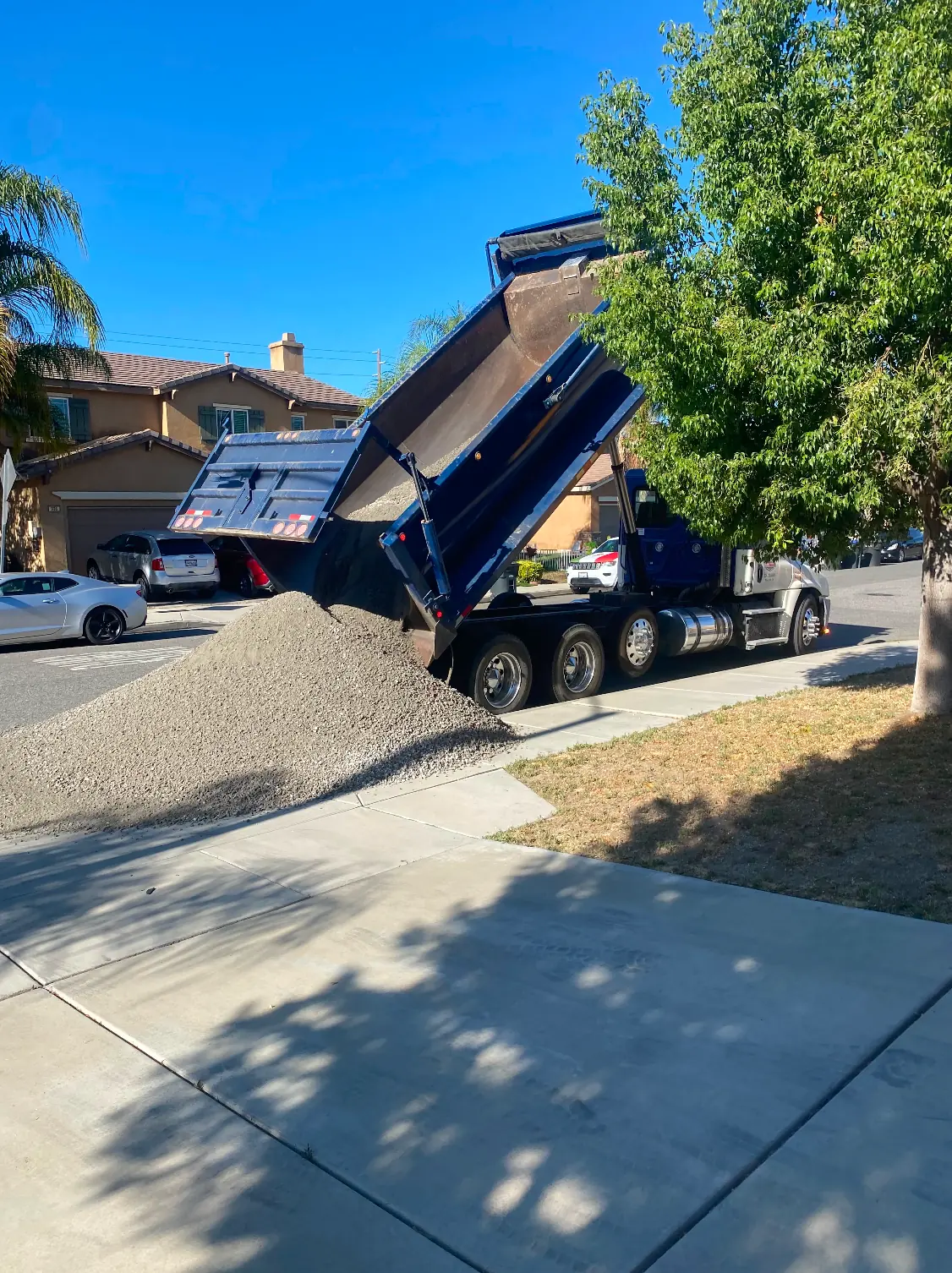 Dump truck delivering base material for an artificial grass job in Perris, CA