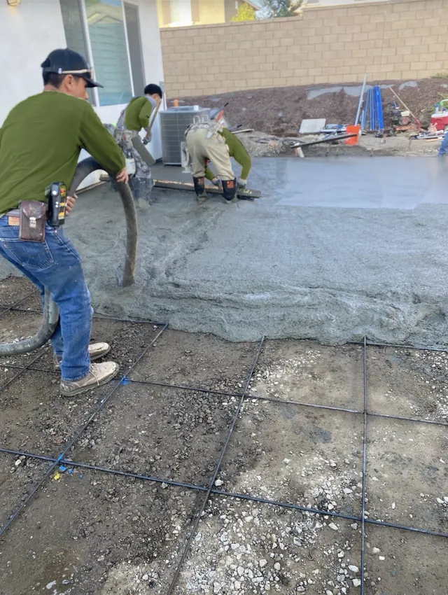 Crew pouring a concrete patio slab