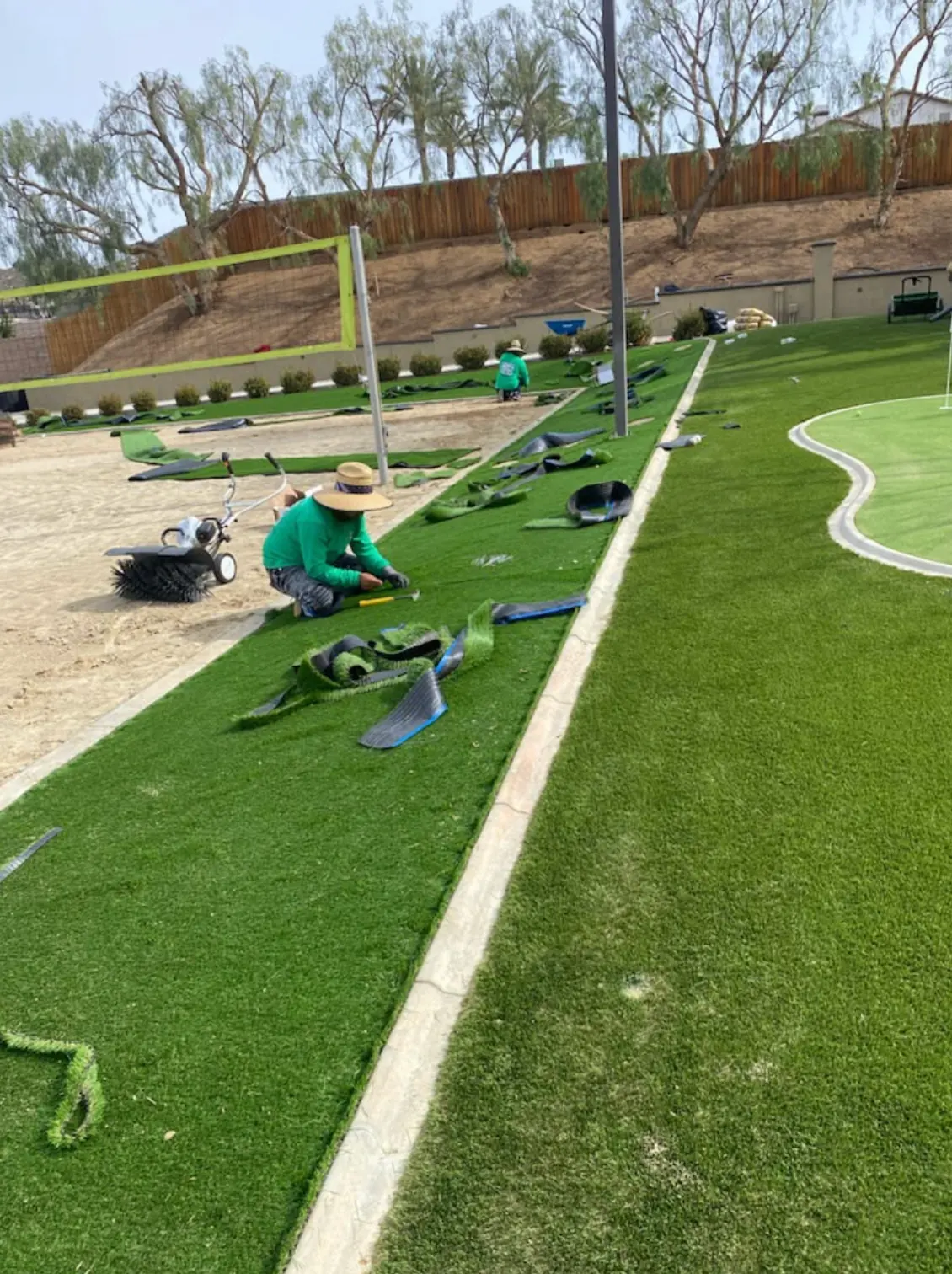 Crew working on irrigation and edges in a Perris, CA yard