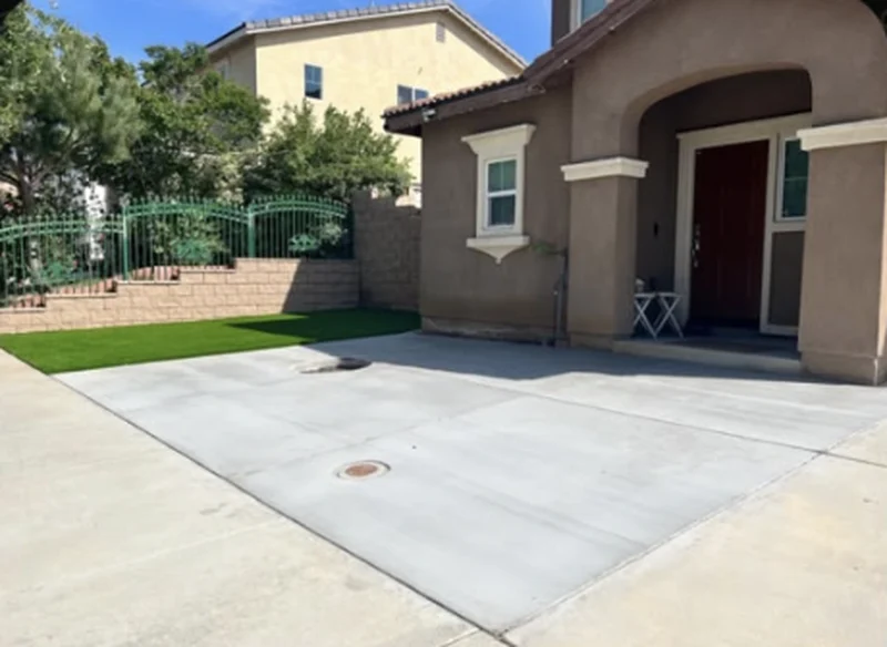 Front yard with a concrete driveway and new artificial grass
