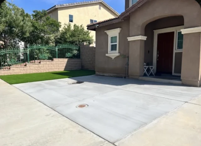 Front yard with a concrete driveway and new artificial grass