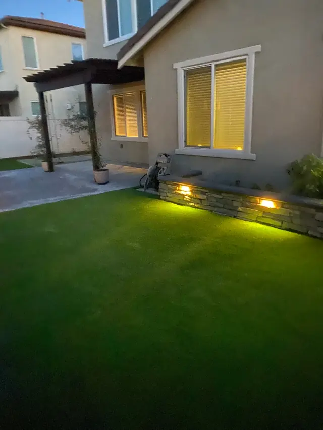 Front yard at dusk with landscape lighting in Perris, CA