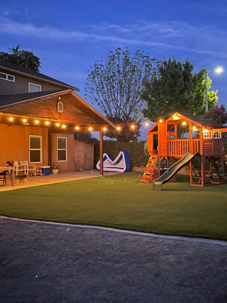 Patio at night with landscape lighting in Perris, CA