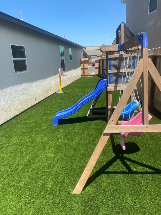 Playground turf under a swing set in Perris, CA