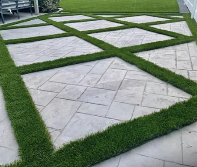 Stamped concrete pads with artificial grass between them
